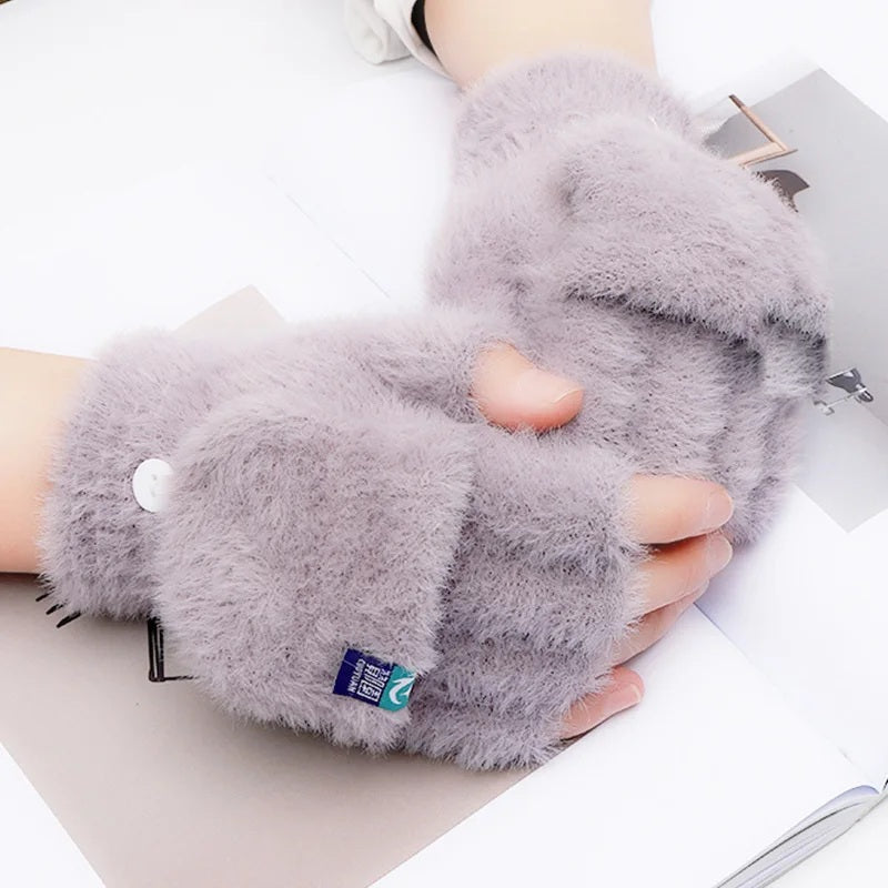Grey plush fingerless glove close-up on a desk