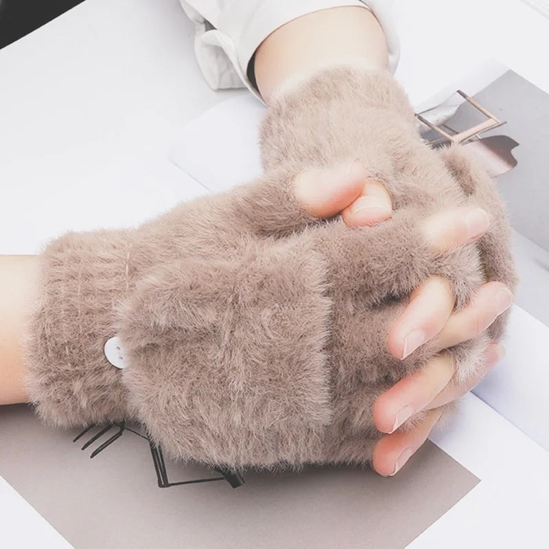 Taupe plush fingerless gloves worn, hands resting
