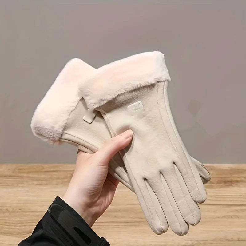 Hand holding a pair of cream fur-cuffed touchscreen gloves