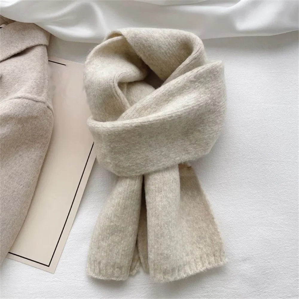 Oatmeal cashmere scarf wrapped and knotted, flat lay
