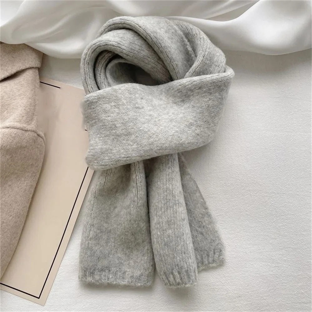 Light grey cashmere scarf wrapped and knotted, flat lay