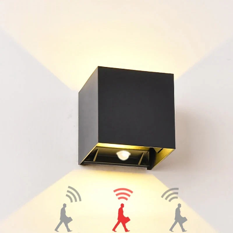 Black square LED wall lamp with motion sensor lighting a wall up and down