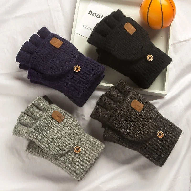Knitted fingerless gloves in four colours arranged on a white surface