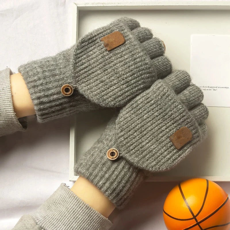 Pair of grey knitted fingerless gloves worn on both hands