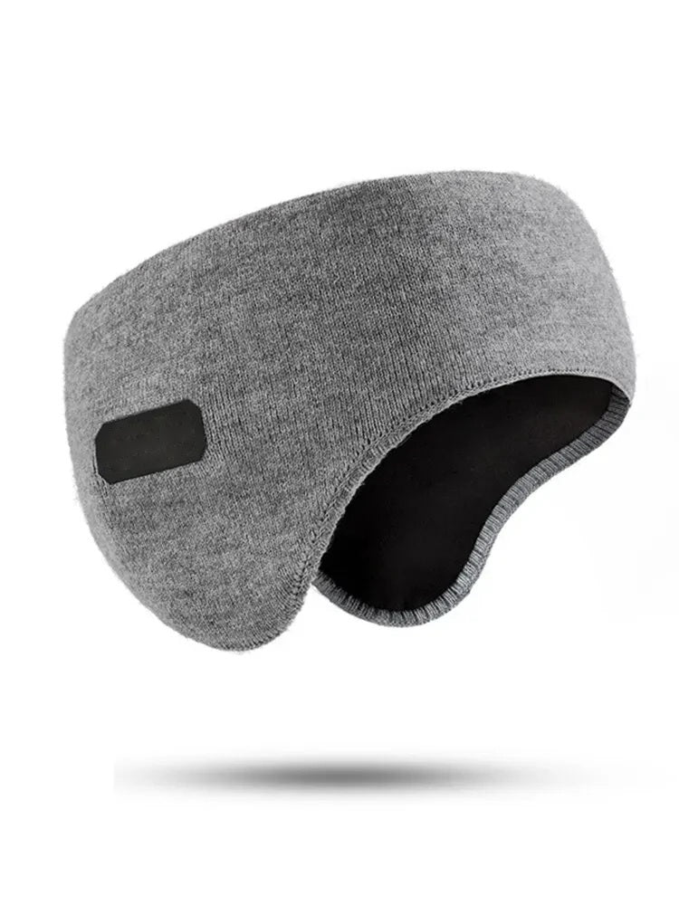 Grey knitted ear muff headband on a white background