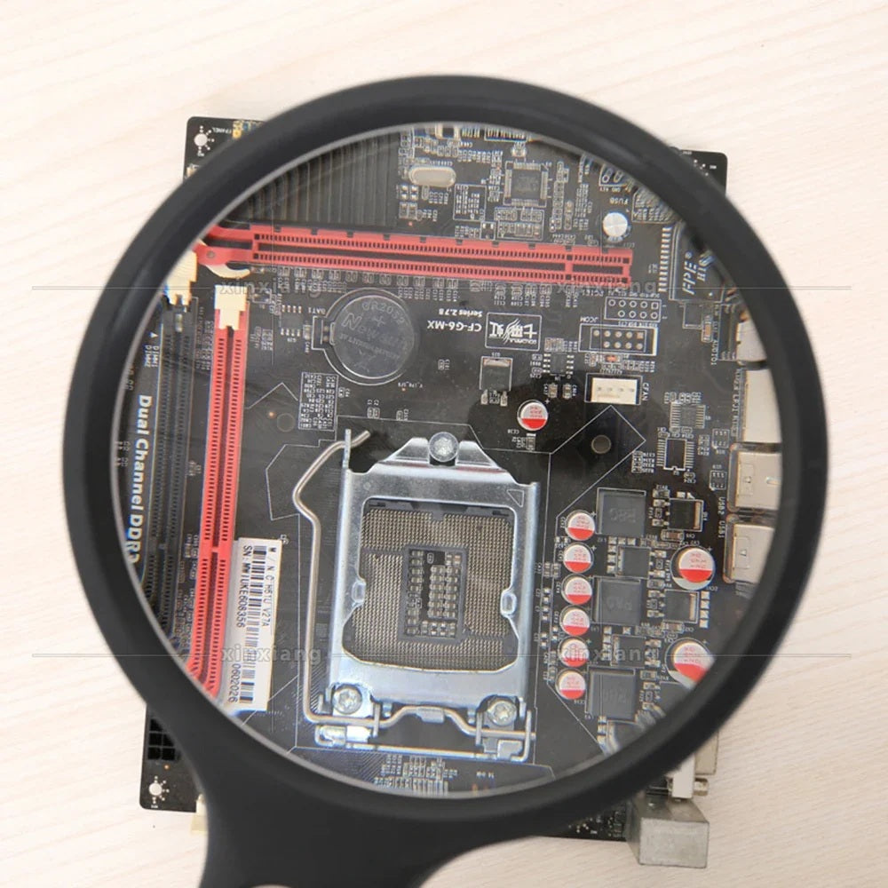 Magnifying glass enlarging the components on a computer motherboard