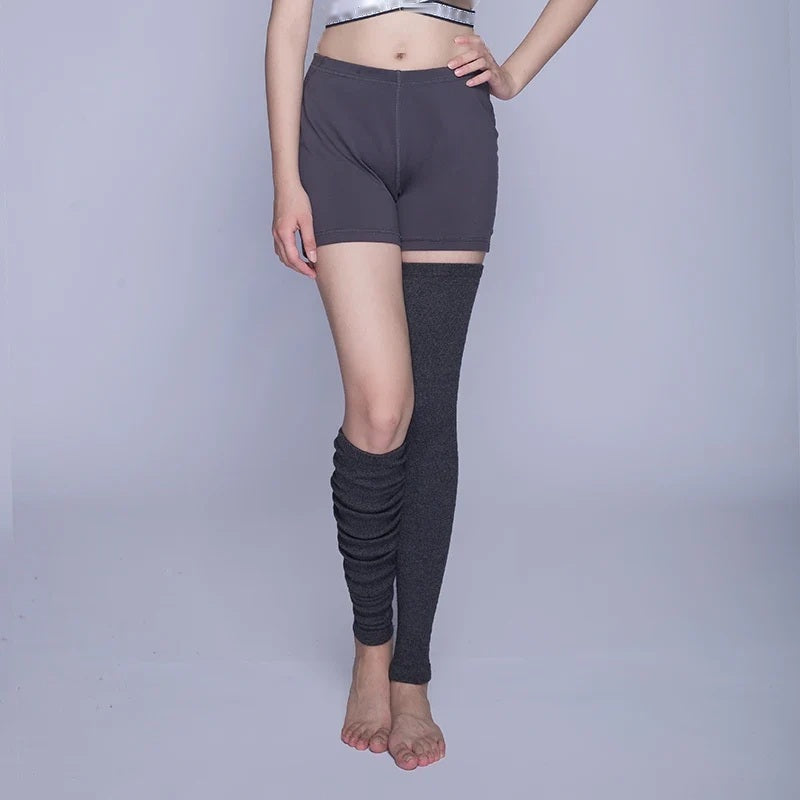 Model wearing charcoal knitted thigh-high leg warmers, front pose