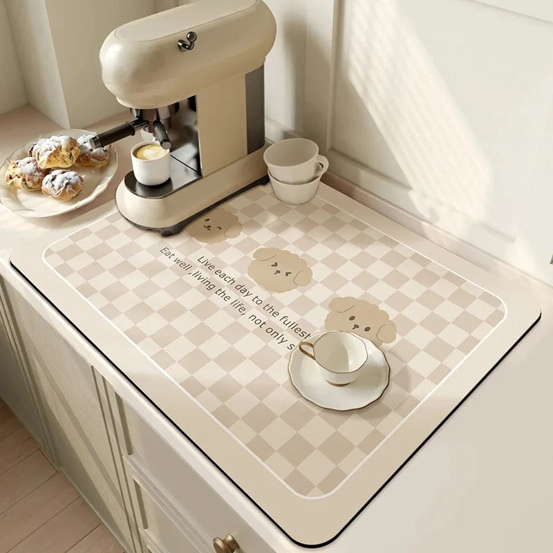 Checkered absorbent kitchen mat on a counter beside an espresso machine