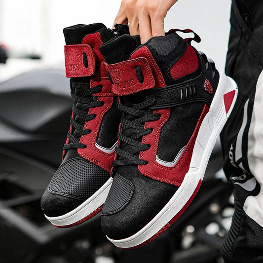 Rider holding a pair of red and black motorcycle riding shoes