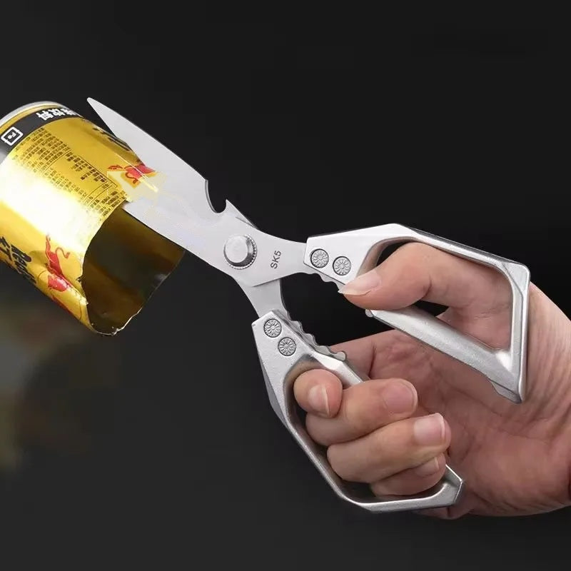 Kitchen scissors using the built-in bottle opener on a can