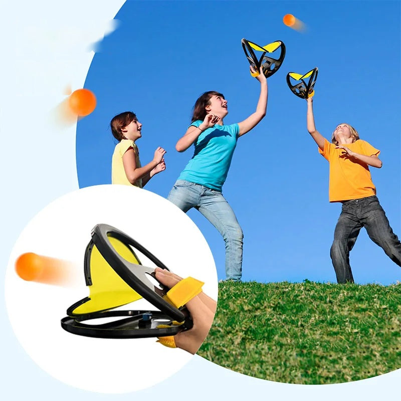 Children playing a toss and catch ball game outdoors on grass