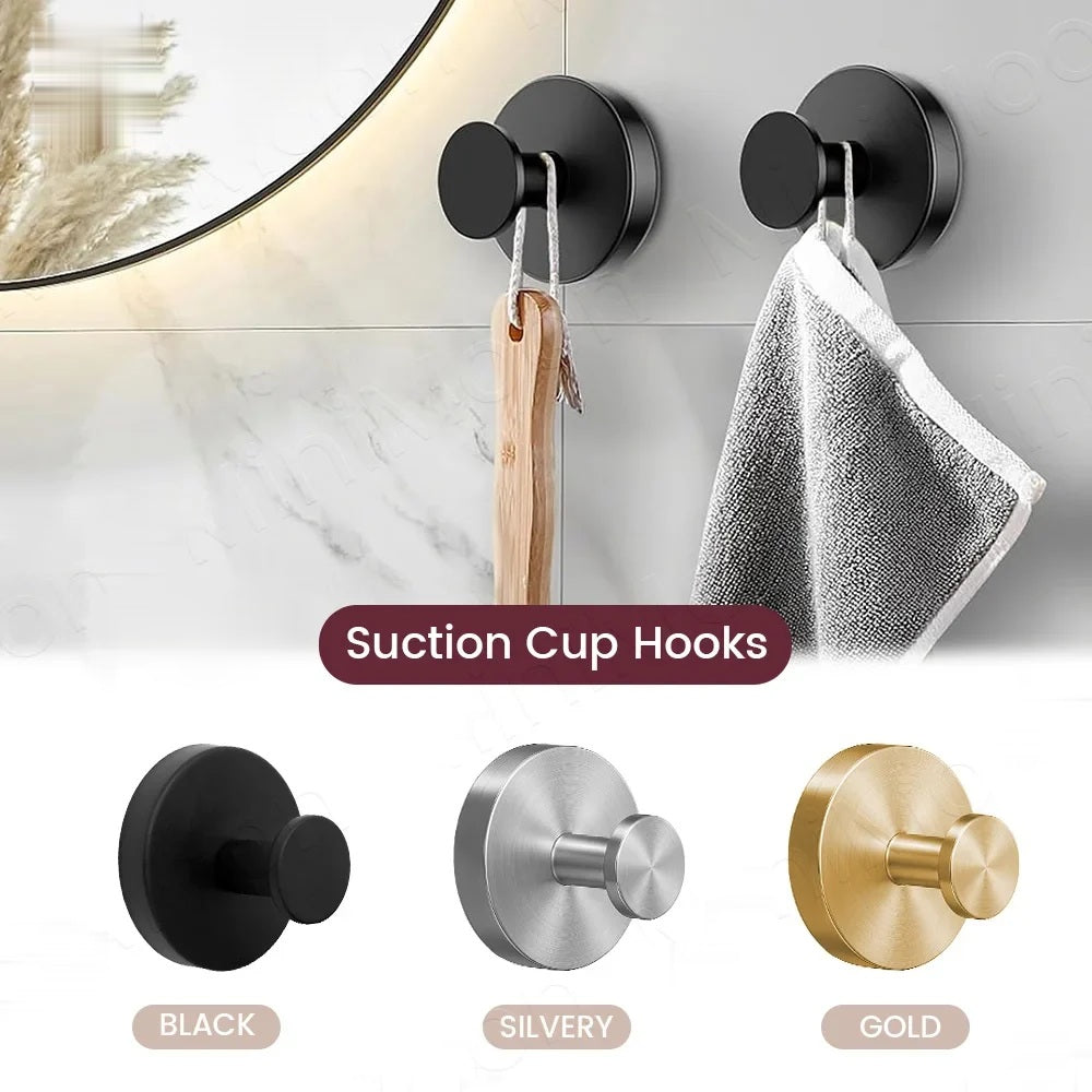 Suction cup hooks holding a towel on a bathroom wall, with black, silver and gold finishes shown below