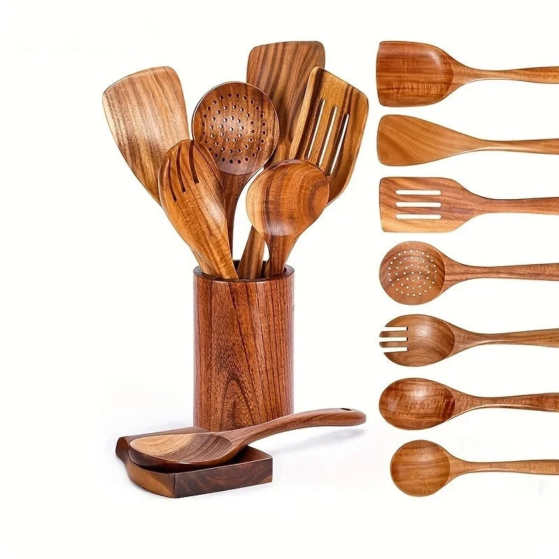 Wooden kitchen utensil set in a holder with spoons and spatulas on white