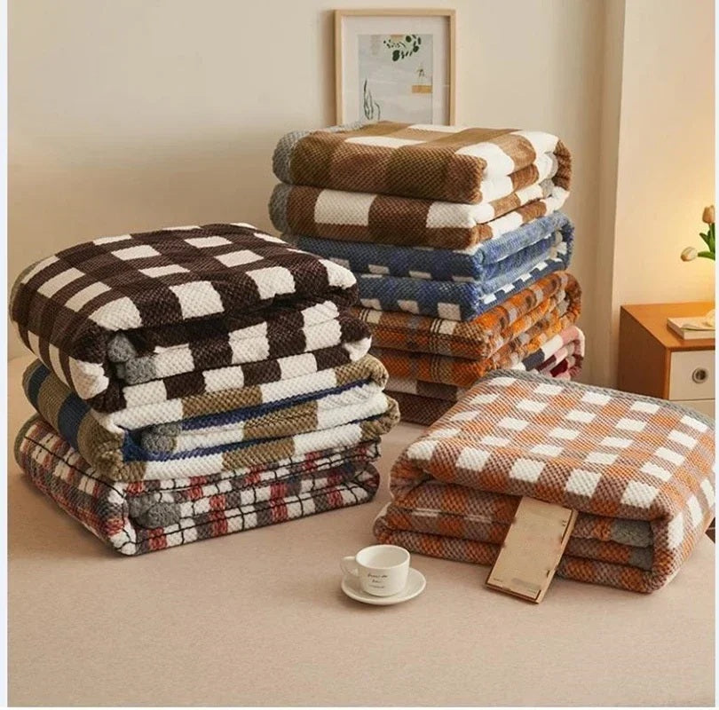Stacked chenille knit throw blankets in several colourways