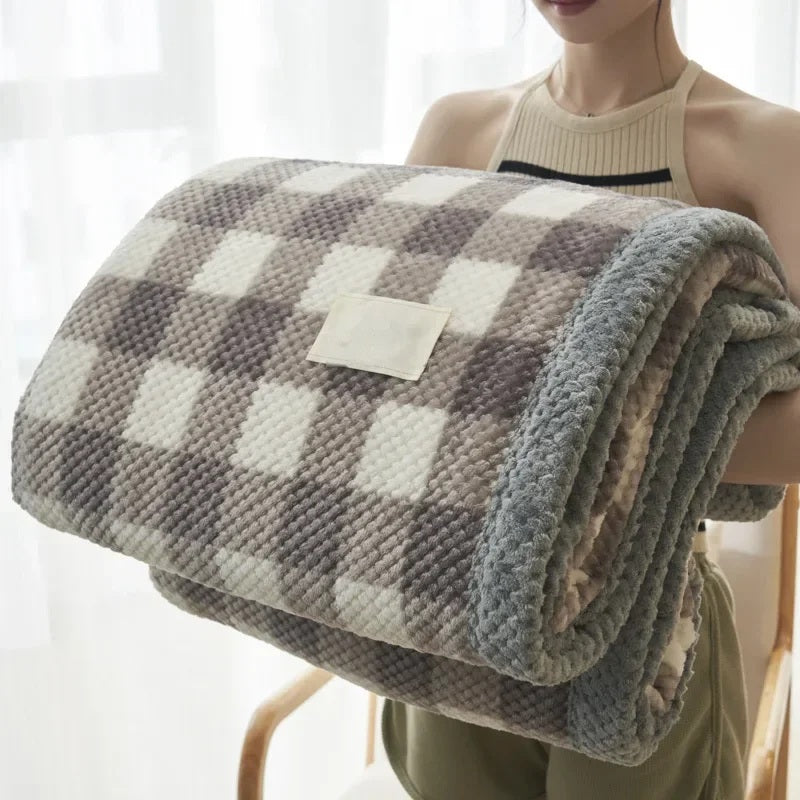 Rolled chenille knit throw blanket held in the arms, cream check