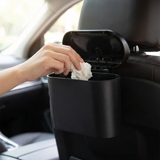 Hand opening the hanging car trash bin fitted behind a car seat