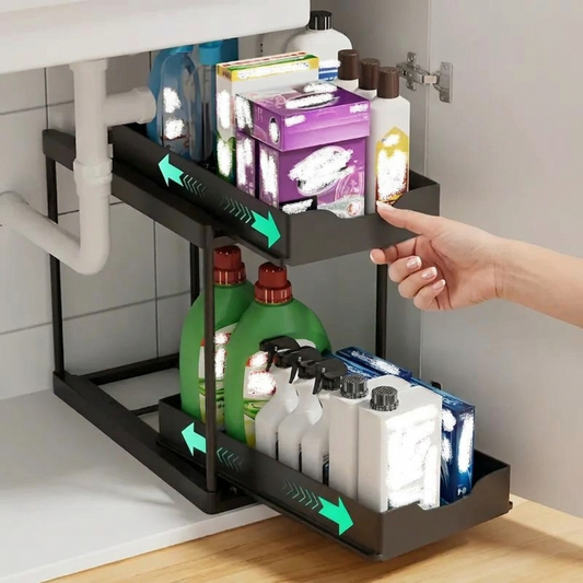 Hand sliding out the 2-tier pull-out storage rack under a kitchen sink